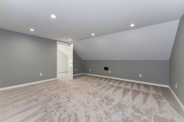 bonus room featuring light carpet and vaulted ceiling