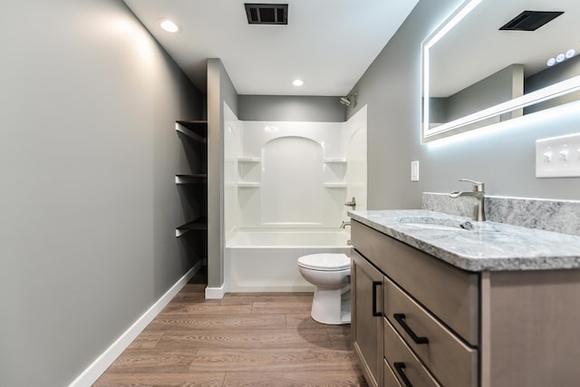 full bathroom with hardwood / wood-style floors, vanity, toilet, and shower / bathing tub combination