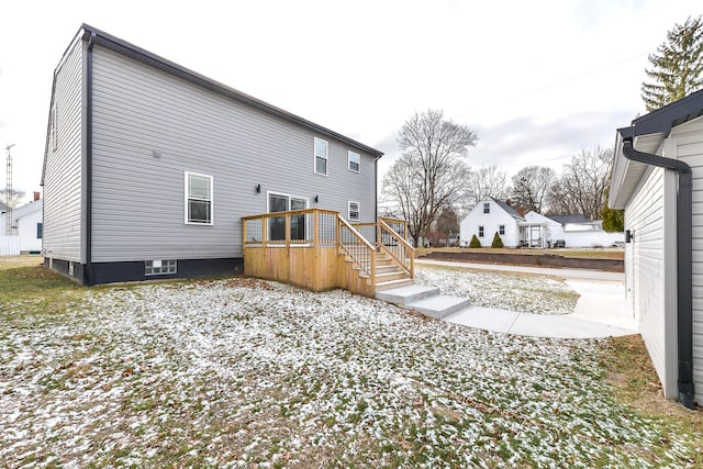 rear view of property featuring a wooden deck