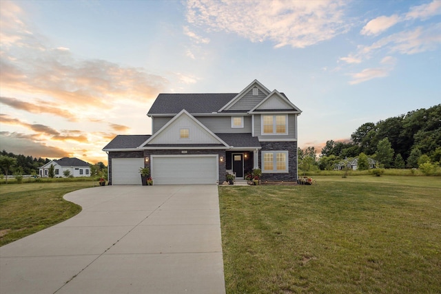 craftsman-style home featuring a lawn and a garage