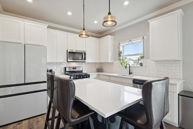 kitchen featuring white cabinets, sink, and appliances with stainless steel finishes