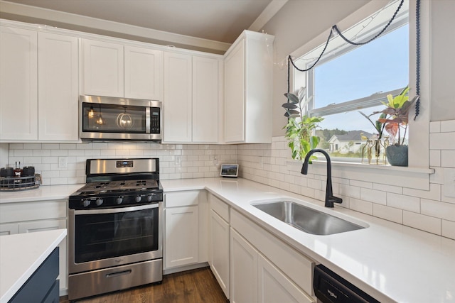 kitchen with sink, white cabinets, and stainless steel appliances