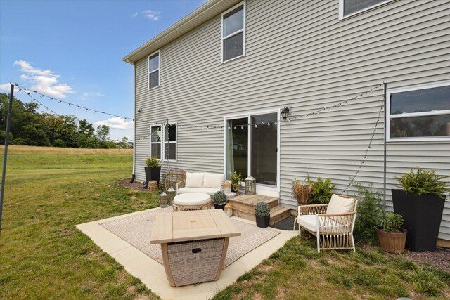 back of house with outdoor lounge area and a yard