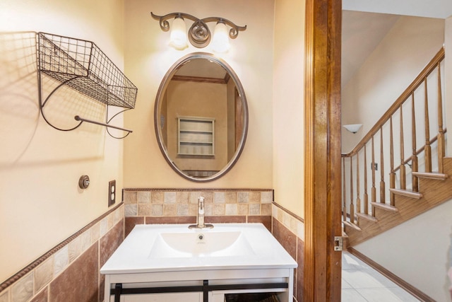 bathroom featuring tile patterned floors, sink, and tile walls