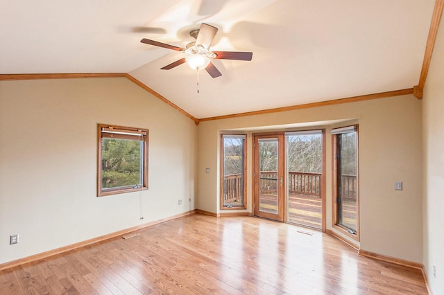 unfurnished room featuring light hardwood / wood-style flooring, vaulted ceiling, ceiling fan, and a healthy amount of sunlight