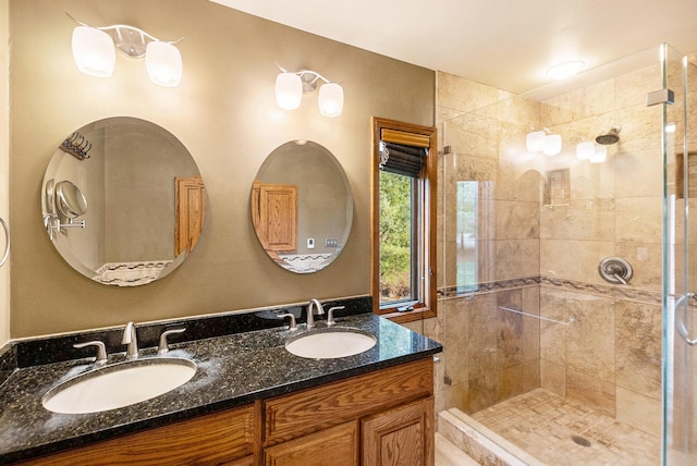 bathroom with a tile shower and vanity