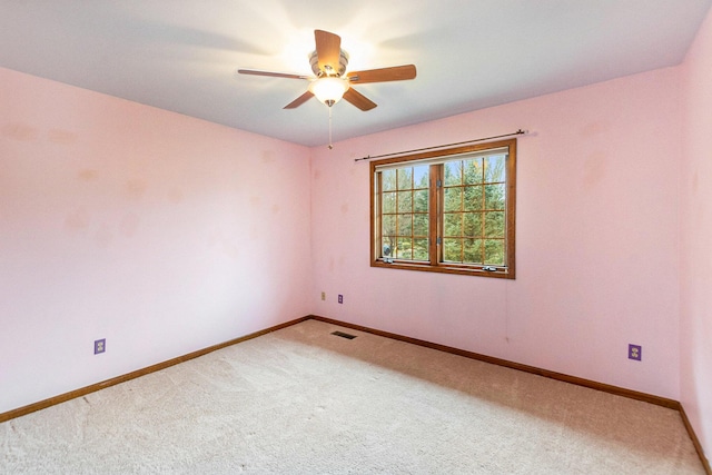 empty room featuring ceiling fan and carpet floors