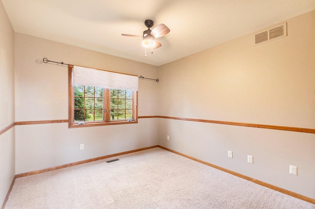 carpeted spare room featuring ceiling fan