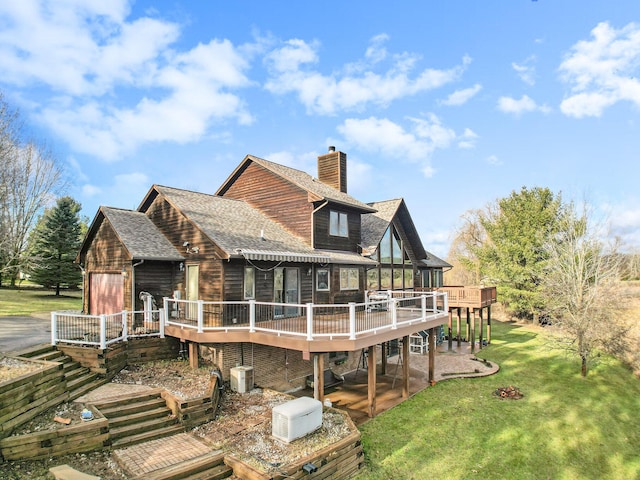 rear view of house featuring a lawn, a wooden deck, and central air condition unit