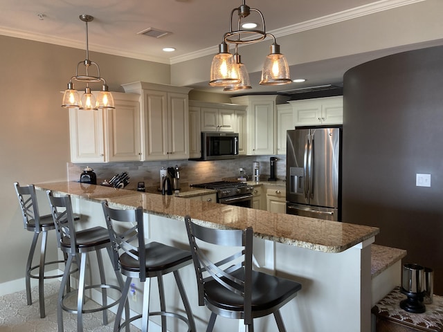 kitchen featuring pendant lighting, decorative backsplash, appliances with stainless steel finishes, kitchen peninsula, and a breakfast bar area