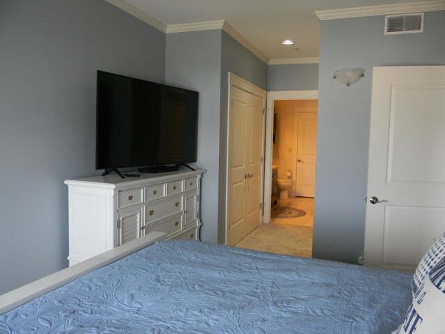 bedroom with ornamental molding and light carpet