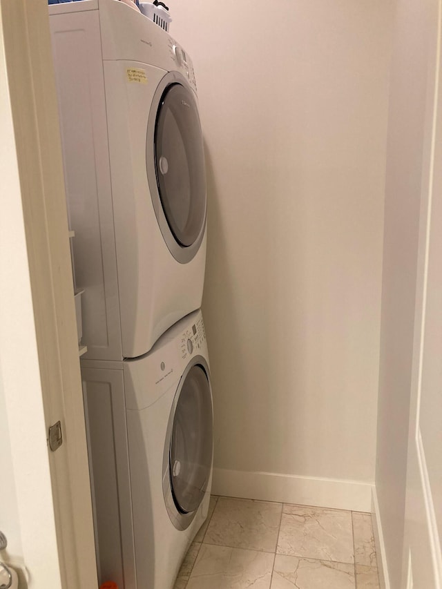 washroom featuring light tile patterned floors and stacked washer / dryer