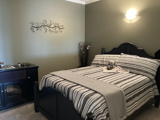 carpeted bedroom with ornamental molding