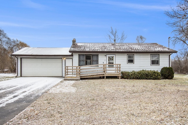 ranch-style house with a wooden deck and a garage