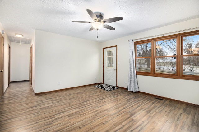 unfurnished room featuring a textured ceiling, hardwood / wood-style flooring, and ceiling fan