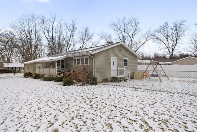 view of snow covered back of property