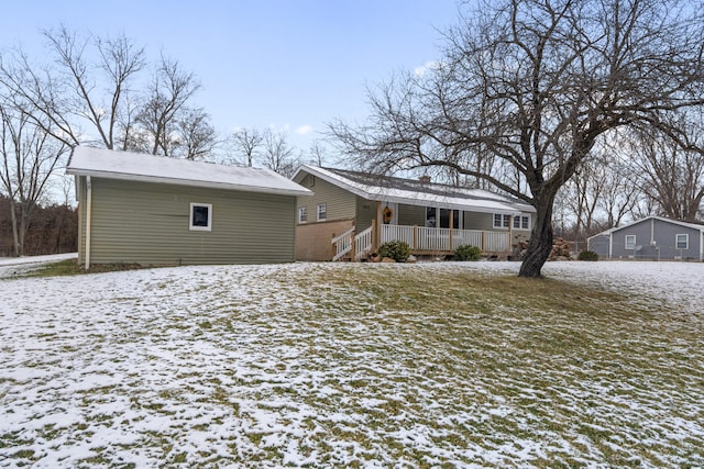 view of snow covered back of property