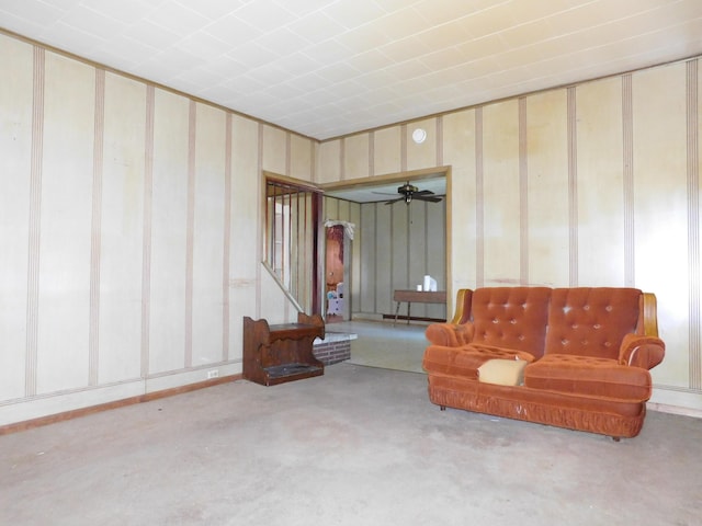 living area featuring light carpet and ceiling fan