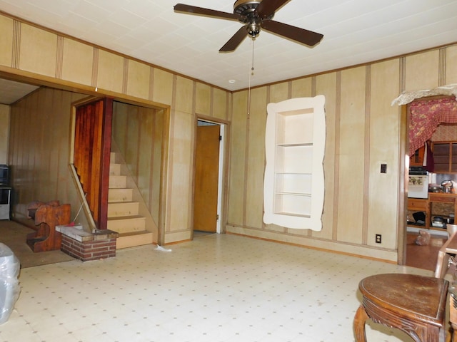 living room featuring ceiling fan and ornamental molding