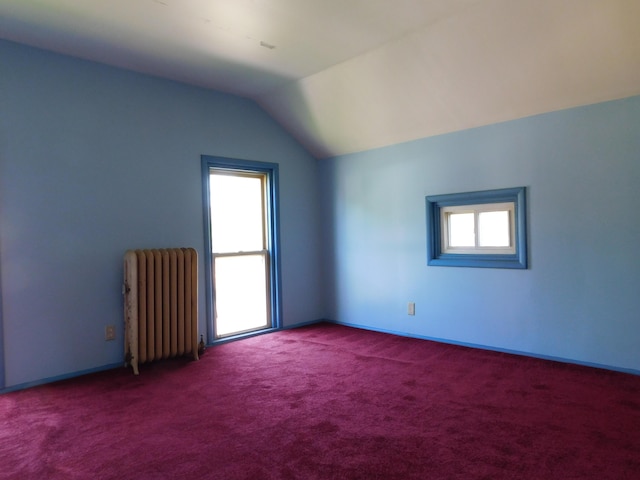 bonus room featuring radiator heating unit, carpet floors, and lofted ceiling