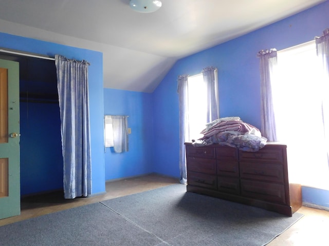 carpeted bedroom featuring lofted ceiling