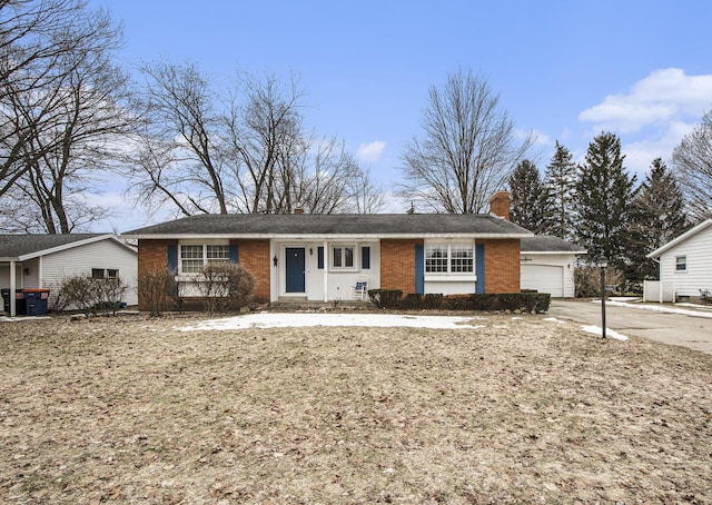 ranch-style home with a garage and brick siding