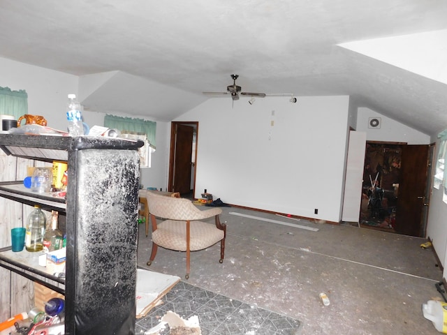 interior space featuring ceiling fan and lofted ceiling