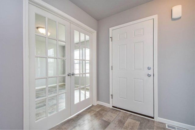 doorway to outside with hardwood / wood-style floors and french doors