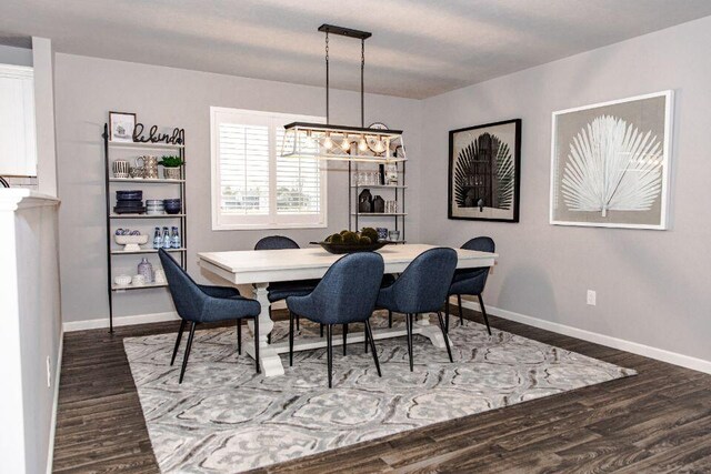 dining room featuring dark hardwood / wood-style flooring and a chandelier