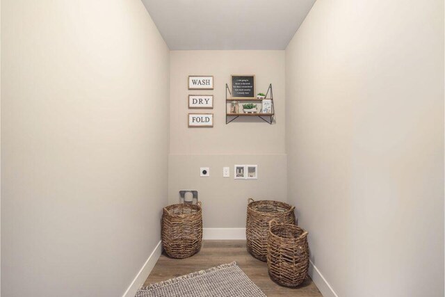 laundry room with hookup for a washing machine, light hardwood / wood-style flooring, and electric dryer hookup