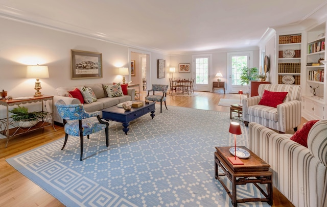 living room with wood-type flooring and ornamental molding