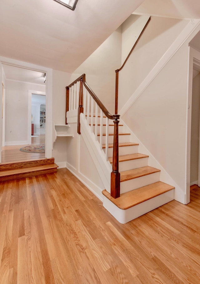 staircase with hardwood / wood-style flooring