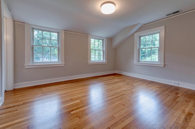 bonus room featuring light hardwood / wood-style floors and vaulted ceiling