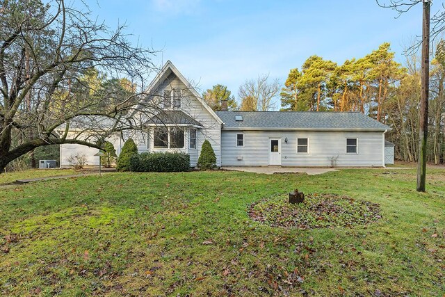 back of house featuring a patio area and a yard