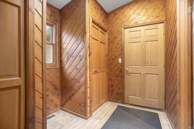 entryway featuring wood walls