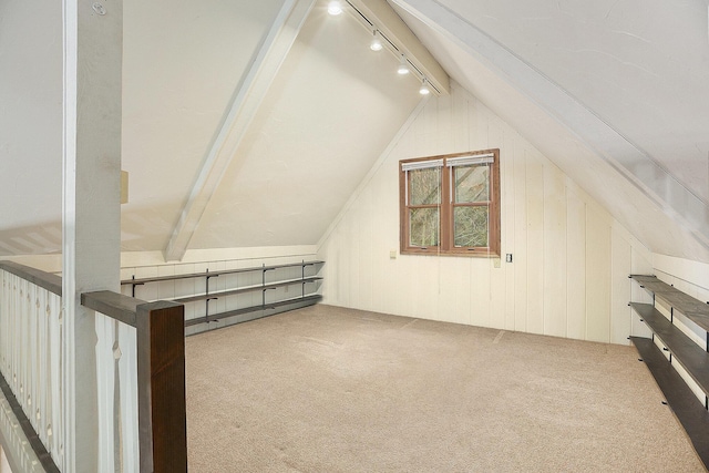 bonus room featuring wooden walls, carpet, and lofted ceiling