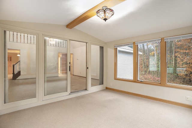 unfurnished sunroom with lofted ceiling with beams