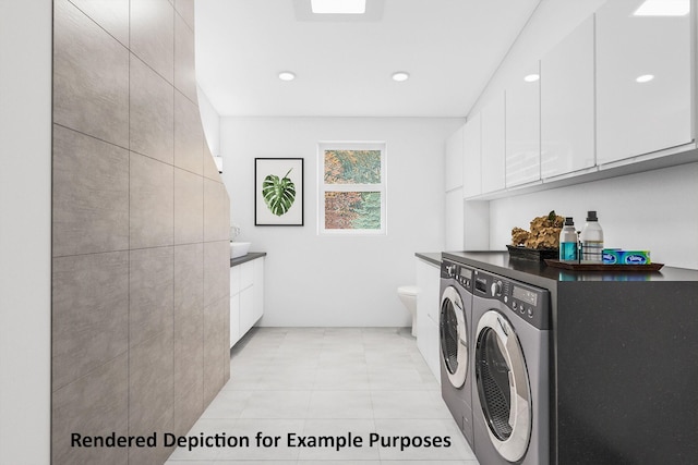 laundry room featuring cabinets and washing machine and clothes dryer