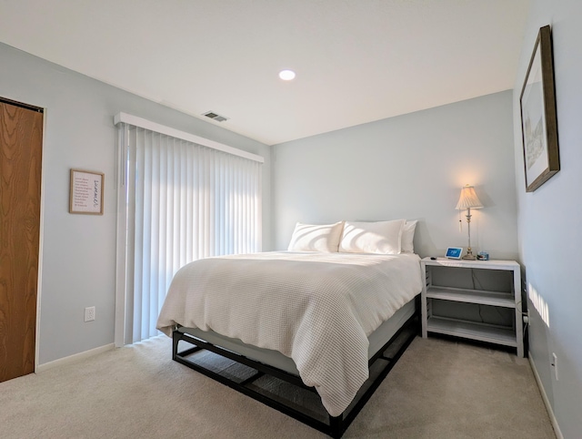 bedroom with light colored carpet