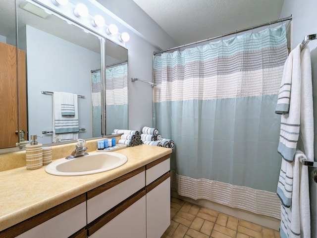 bathroom with a textured ceiling and vanity