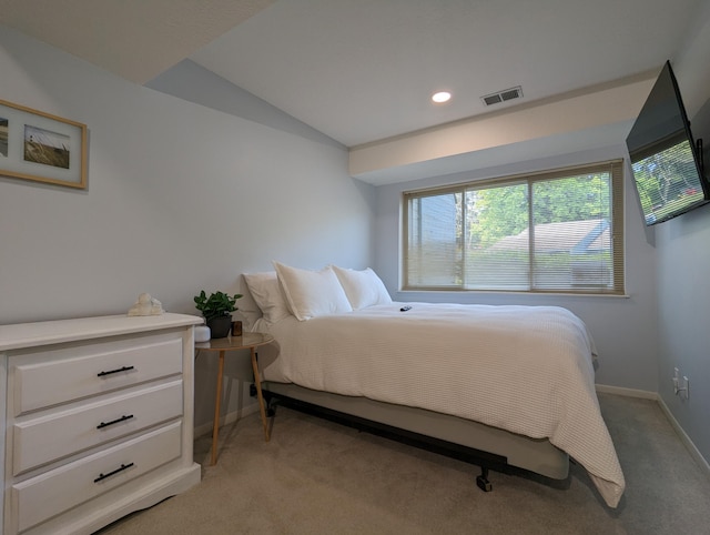 carpeted bedroom with lofted ceiling