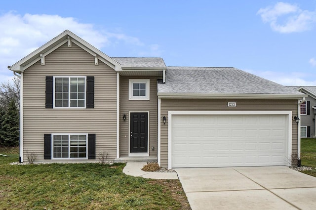 view of front of house with a garage and a front lawn