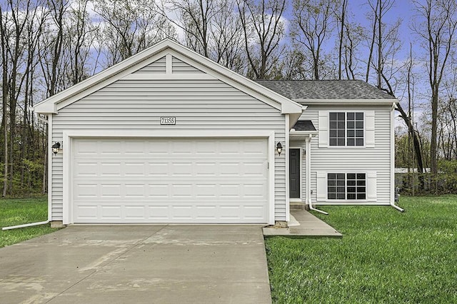 view of front of property with a front yard and a garage