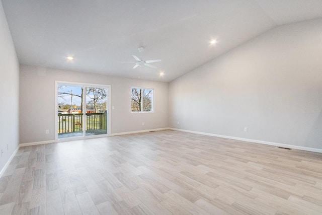 empty room featuring lofted ceiling, light hardwood / wood-style flooring, and ceiling fan