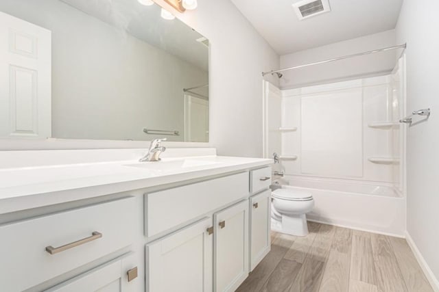 full bathroom with shower / bathing tub combination, vanity, wood-type flooring, and toilet