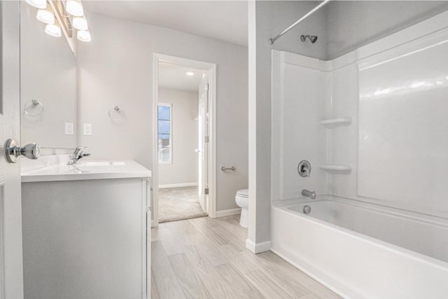 full bathroom featuring vanity, wood-type flooring, shower / bathtub combination, and toilet