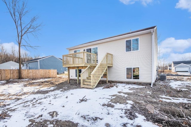 snow covered property featuring a deck and central air condition unit