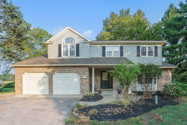 view of front property featuring covered porch and a garage