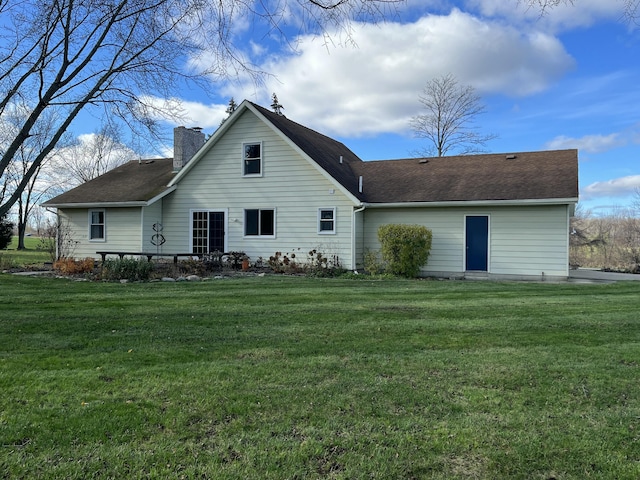 rear view of house with a yard