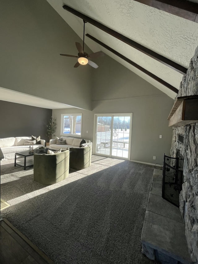 living room with a fireplace, high vaulted ceiling, a textured ceiling, carpet flooring, and beam ceiling